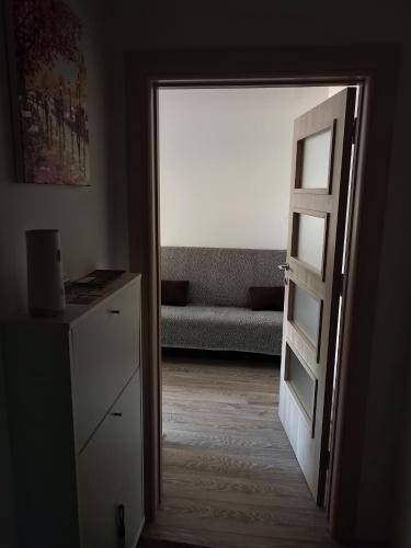 an open door to a living room with a couch at Stančić kraj Morave in Čačak