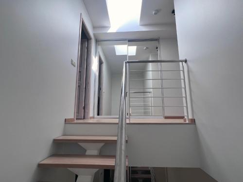 a staircase in a room with a window and a mirror at A stylish & cozy terraced house in Tartu in Tartu