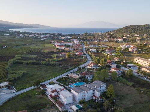 an aerial view of a small town next to the ocean at PAHNIS studios in Alikanas