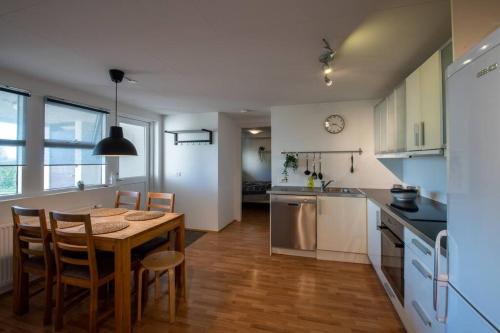 a kitchen and dining room with a table and chairs at Lovely one bedroom apartment in Hafnarfjordur in Hafnarfjördur