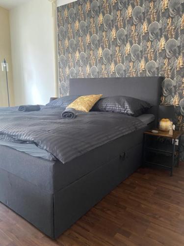 a bed in a bedroom with a wall at Penzion U Radnice in Doksy
