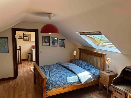 a bedroom with a bed and a skylight at Apartment - Clonlyne House in Oldcastle