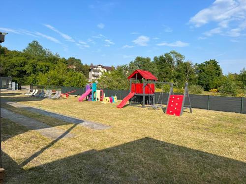 a group of children playing on a playground at Domki letniskowe u Krzysia in Jastrzębia Góra