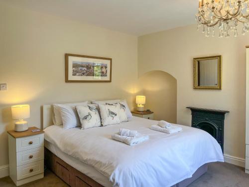 a bedroom with a bed with two towels on it at Puddle Duck Cottage in Bakewell