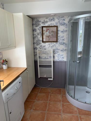 a kitchen with a walk in shower in a room at Entire Farm House stay, La Gérouardière in Barenton