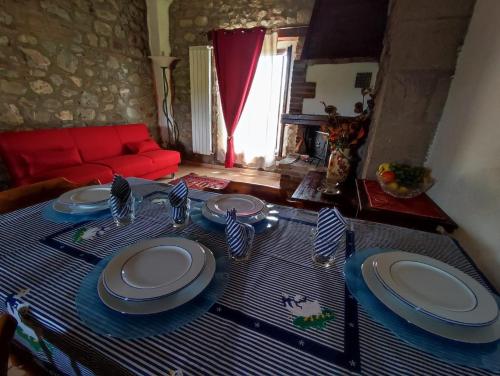a table with plates on it in a living room at Agriturismo Il Borgo della Canapa in San Benedetto