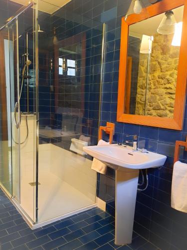 a bathroom with a sink and a shower at Prau Llagar, megustarural in Llanes