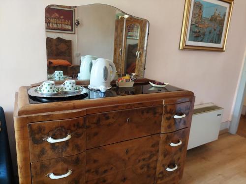 a dresser with a mirror on top of it at Bordeghina B&B In Farmhouse in Pontecchio Polesine