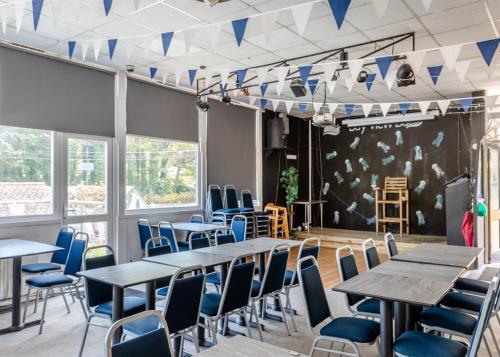 a room with tables and chairs and a wall with flags at Brixham Holiday Park in Brixham