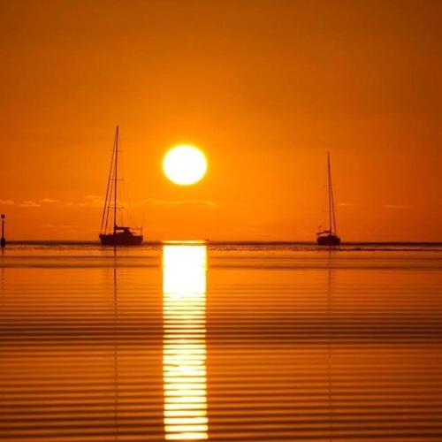 two boats in the water with the sunset in the background at Patagonia Home in Shimoda