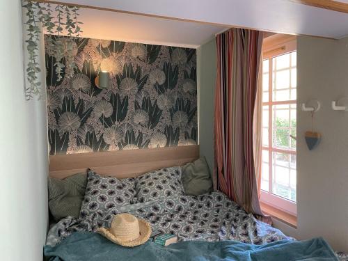 a bedroom with a bed with a hat on it at Cap Estérel Rivièra Studio in Saint-Raphaël