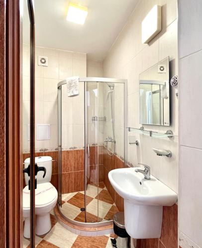 a bathroom with a toilet and a sink and a shower at Sea View in Primorsko