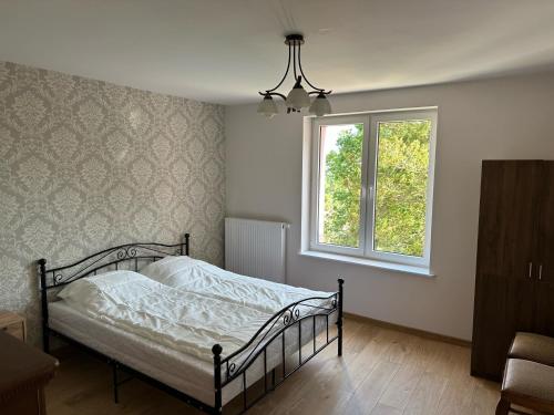 a bedroom with a bed and a window at Apartamenty Oaza Spokoju in Sopot