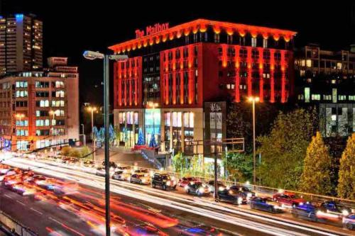 a city at night with traffic on a busy street at Cloudstays Birmingham Luxury Townhouse 2 lakes sleeps upto 8 Free Parking & WIFI in Birmingham