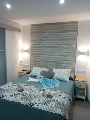 a bedroom with a blue bed with two pillows at La Casita de Ubrique in Ubrique