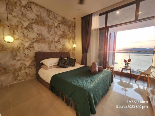 a bedroom with a bed and a large window at Seaview Luxury Suites at The Shore Kota Kinabalu in Kota Kinabalu