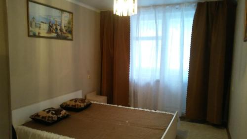 a bedroom with a bed with two pillows on it at Дубоссары ,ул.Ломоносова 8 А in Corjova
