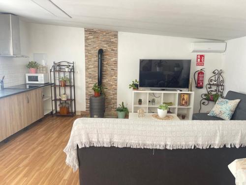 a living room with a table and a kitchen at Finca el atardecer- Apartamento El Peral in Los Santos de Maimona