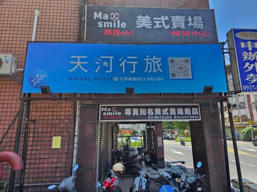 um sinal para uma clínica com motos estacionadas em frente em 天河行旅 em Luodong