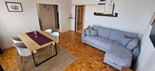 a living room with a couch and a table at Apartments Vila Zagorje in Stinica