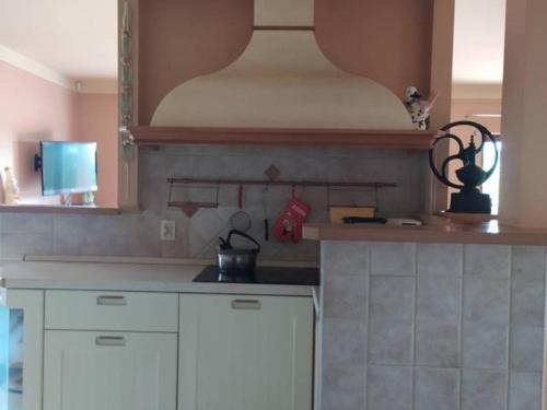 a kitchen with white cabinets and a counter top at Apartament Vip Marysieńka in Kąty Rybackie