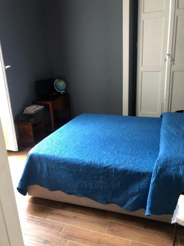 a bedroom with a blue bed with a blue comforter at Casa Renata in Foggia