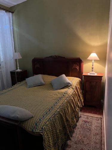 a bedroom with a bed with two pillows on it at Menton1974 in Menton