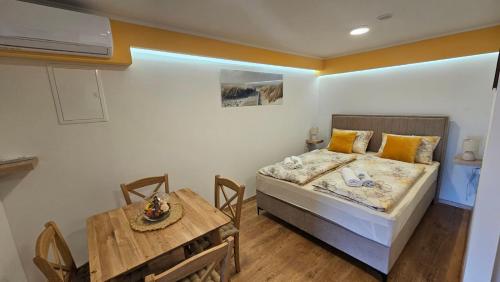 a bedroom with a bed and a dining table at Sabi2 in Mošćenička Draga