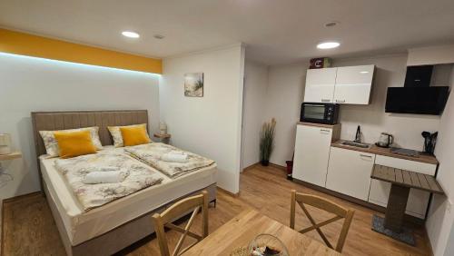 a small bedroom with a bed and a kitchen at Sabi2 in Mošćenička Draga