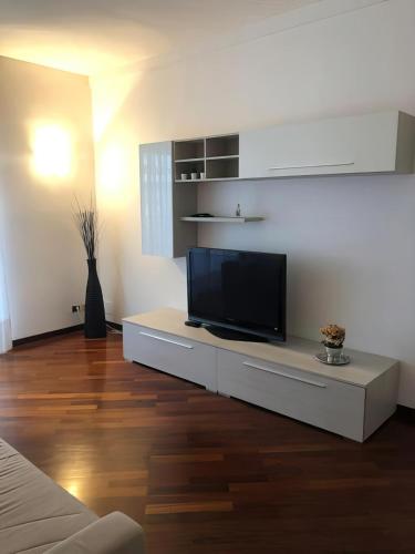 uma sala de estar com uma televisão de ecrã plano sobre uma mesa em AL54 Apartment em Milão