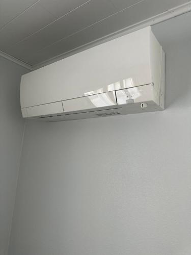 a white light hanging from a ceiling in a room at Iiris in Imatra