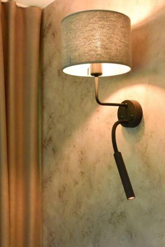 a lamp on a wall in a room at Fridis&Chill in Sigulda