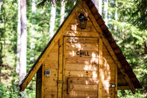 a small tree house with a door in the woods at Fridis&Chill in Sigulda