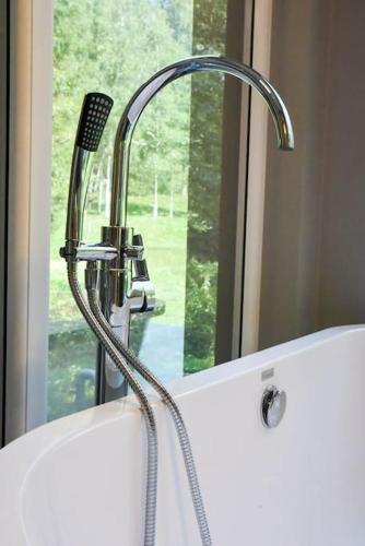 a sink with a faucet next to a window at Fridis&Chill in Sigulda