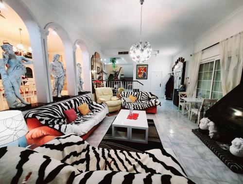 a living room with zebra patterned couches at Villa Matias Pool and beach in Playa de Palma