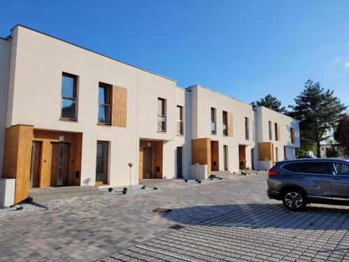 a car parked in front of a row of buildings at Leszka Loft Apartment in Wodzisław Śląski