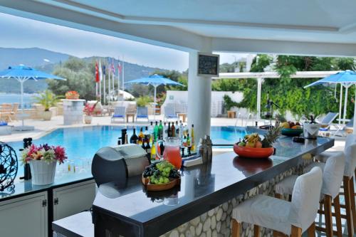 a bar with a view of a swimming pool at Torbahan Hotel in Torba