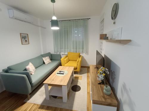a living room with a couch and a table at Apartment Eight - Pirot in Pirot