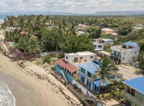 an aerial view of a beach with houses and trees at CasaDePlaya Cabarete Beachfront in Cabarete