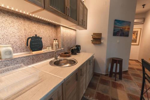 a kitchen with a sink and a counter at AKAVA garden house in Volos