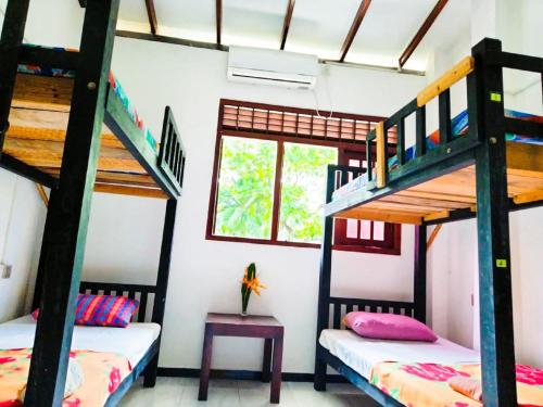 um quarto com 2 beliches e uma mesa em Backpacker Galle Hostel em Galle