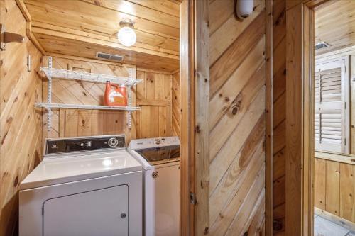 una cocina con lavadora y secadora en una casa pequeña en Smokey Max Chalet, en Sevierville