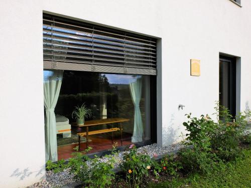 a window of a house with a table and a blind at Cozy Place in Müllendorf