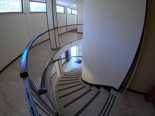 a winding spiral staircase in a building at Garda Panoramic House in Albisano