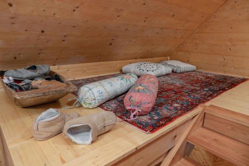 a sauna with pillows and a rug on a wooden floor at Almhaus Gensbach in Innerkrems