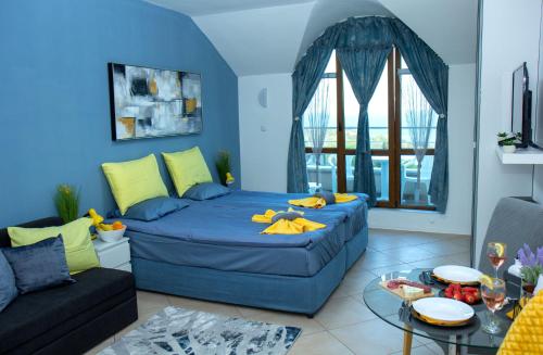 a blue living room with a couch and a table at Black sea Narcissus - quiet studio with amazing sea view in Varna City