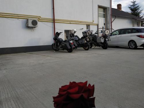 a group of motorcycles parked in a parking lot at Casa Agape in Piteşti