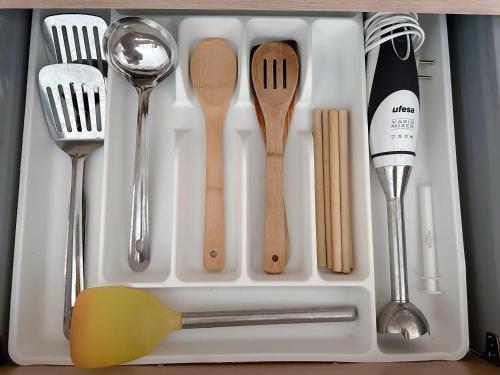 a tray with spoon spatulas and other kitchen utensils at Sa Boadella - Fenals Beach in Lloret de Mar
