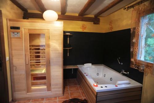 a large bathroom with a tub and a shower at El Rincón de Monasterio in Monasterio