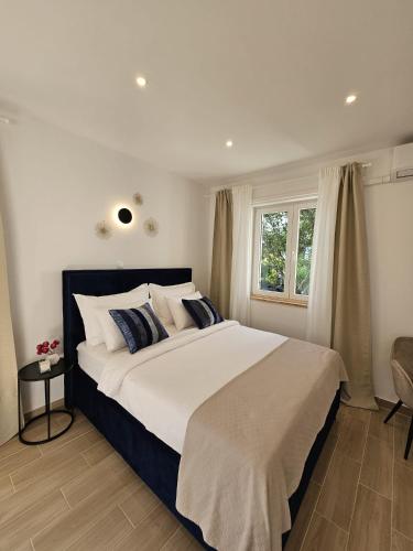a bedroom with a large bed and a window at Studio Ivona in Poreč